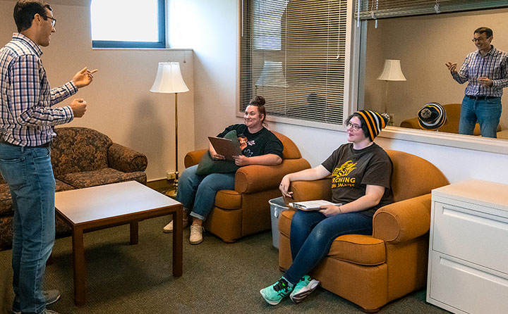 professor instructing students in psychology lab